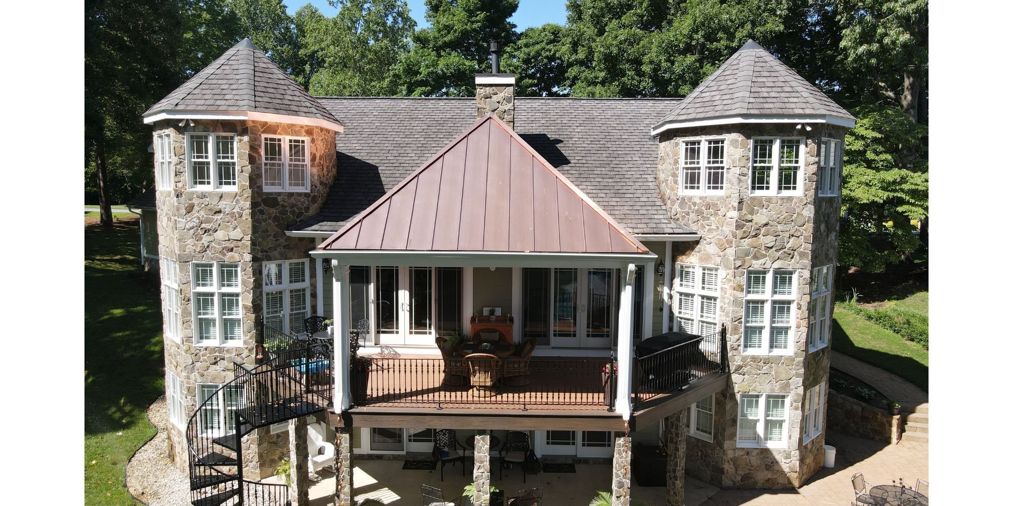Grace Alon custom stone exterior home with twin turrets and upper deck in Roanoke, VA