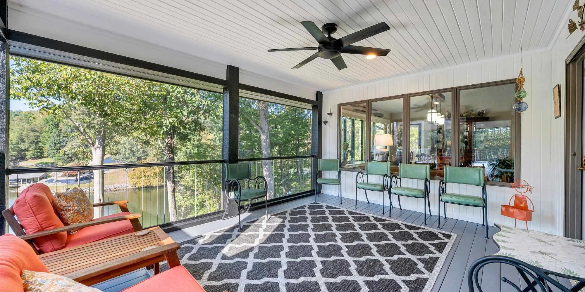 A comfortable outdoor home addition overlooking Smith Mountain Lake by Grace Alon Builders.