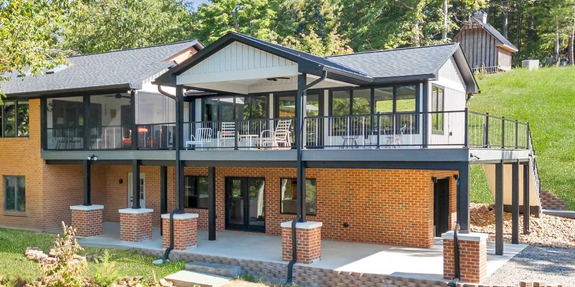 Exterior view of a second-story addition with a wraparound deck by Grace Alon Builders in Roanoke, VA.