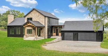 Custom home in Roanoke, VA by Grace Alon Builders featuring black siding, stone exterior, and modern farmhouse design