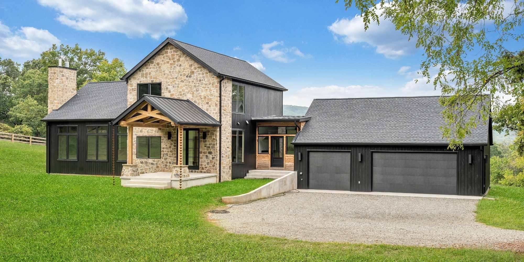 Custom home by Grace Alon Builders in Roanoke, VA featuring black siding, stone exterior, and modern farmhouse design