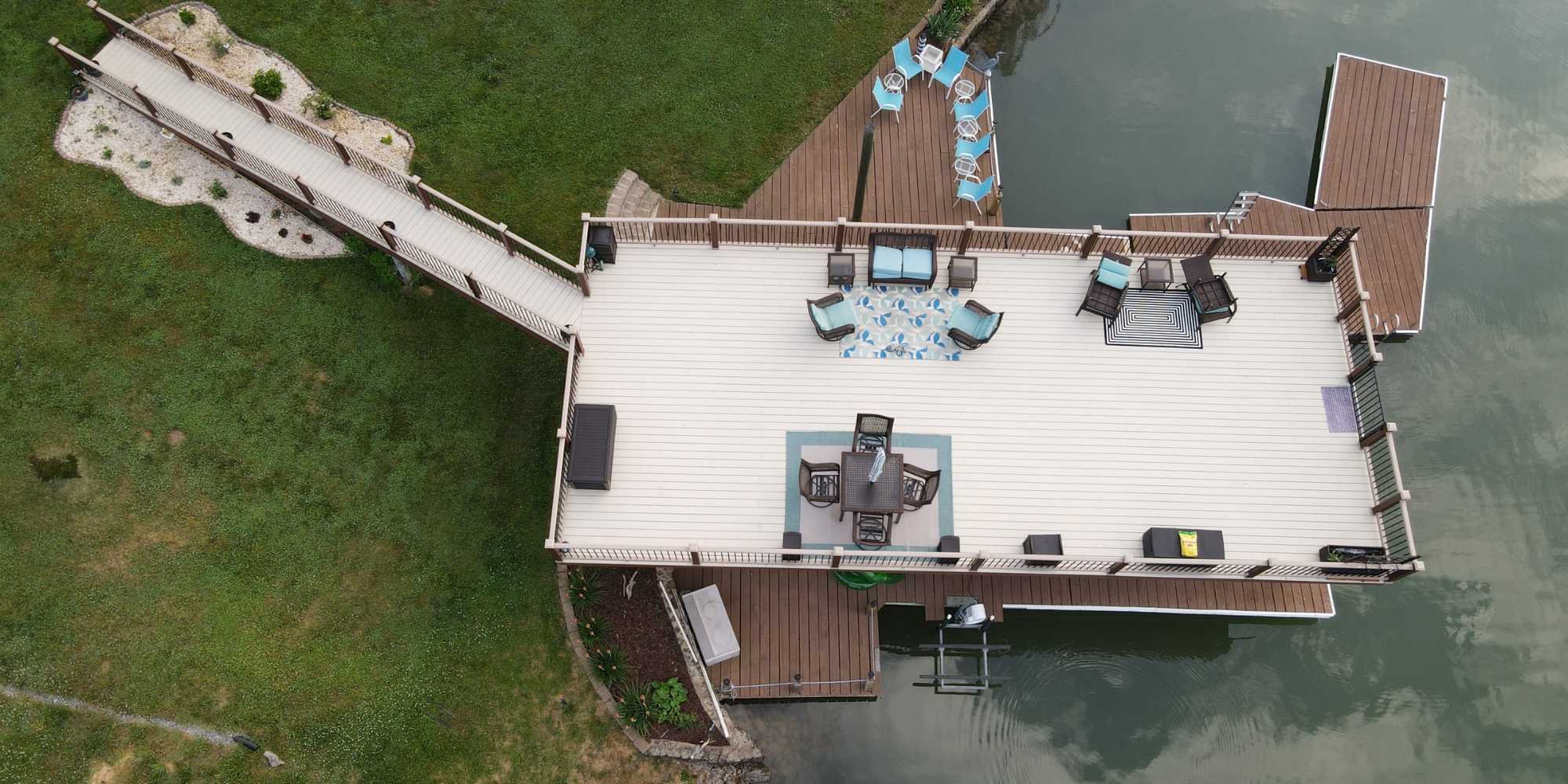 Spacious waterfront dock with seating and lounge area designed by Grace Alon Custom Home Builder in Roanoke