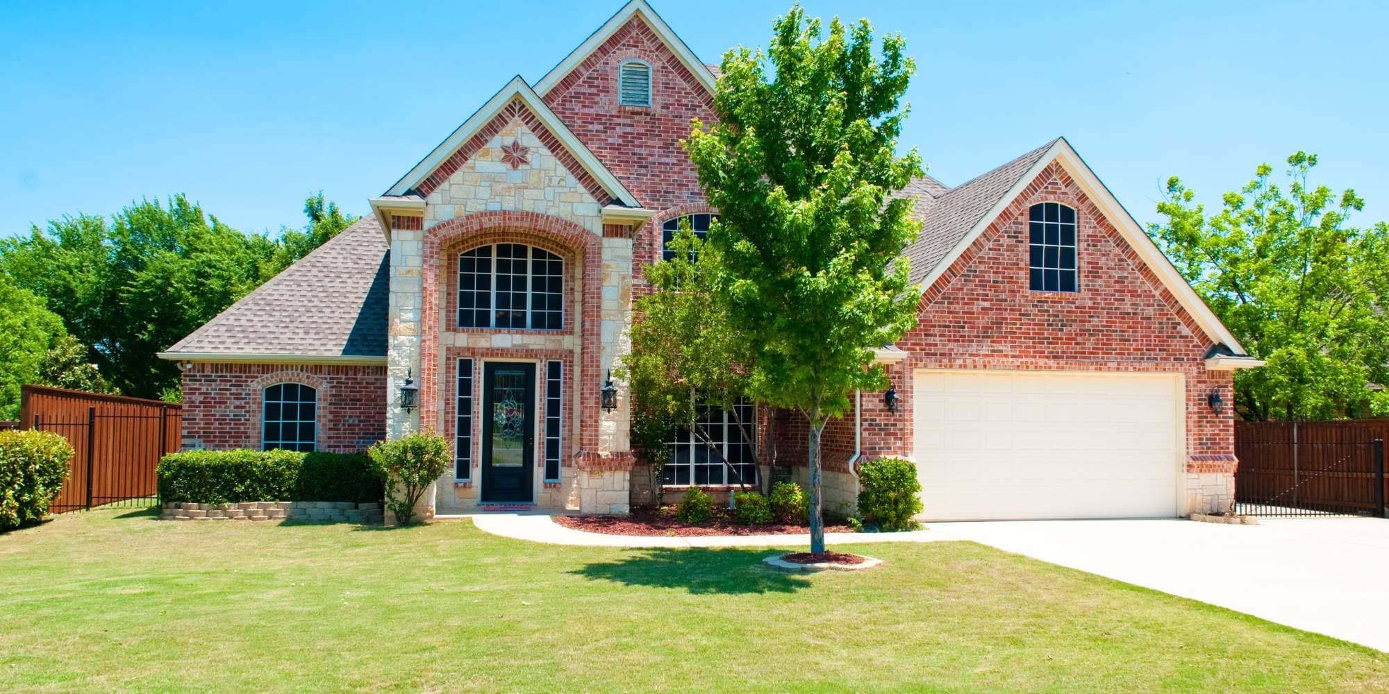 Two-story red brick custom home with stone accents in Roanoke County Custom Home Builder