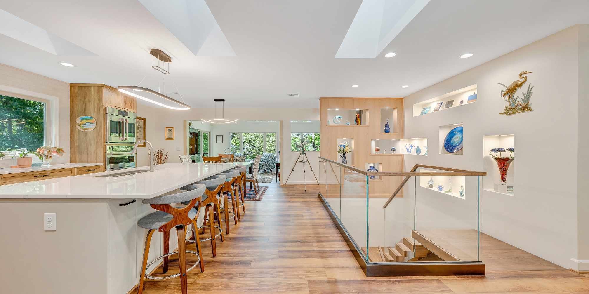 High-end kitchen design with display shelving and skylight lighting by Grace Alon Builders