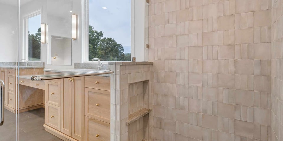 Image of a custom bathroom with glass shower and dual-sink vanity by Grace Alon Builders at Smith Mountain Lake, VA