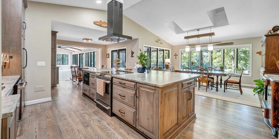 Image of a large kitchen island with cooktop, oven, and microwave built in by Grace Alon Builders at Smith Mountain Lake