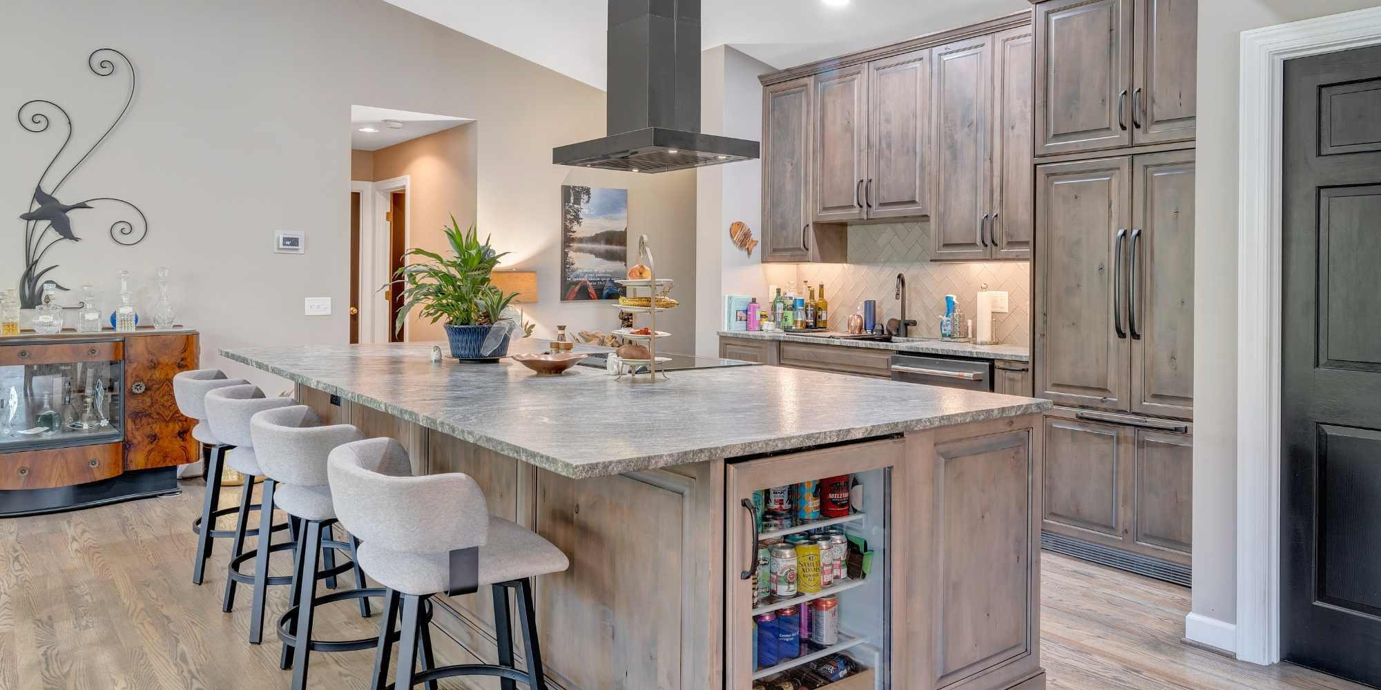 Kitchen in home addition in Smith Mountain Lake, VA by Grace Alon Builders featuring bar seating and built-in storage