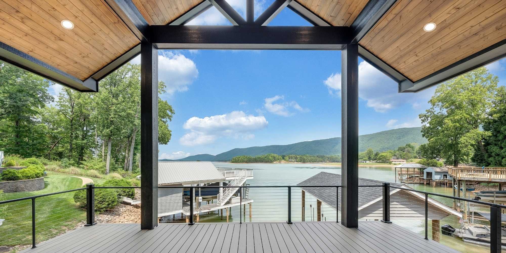 View from a Smith Mountain Lake covered deck home addition looking out over the lake and surrounding mountains by Grace Alon Builders