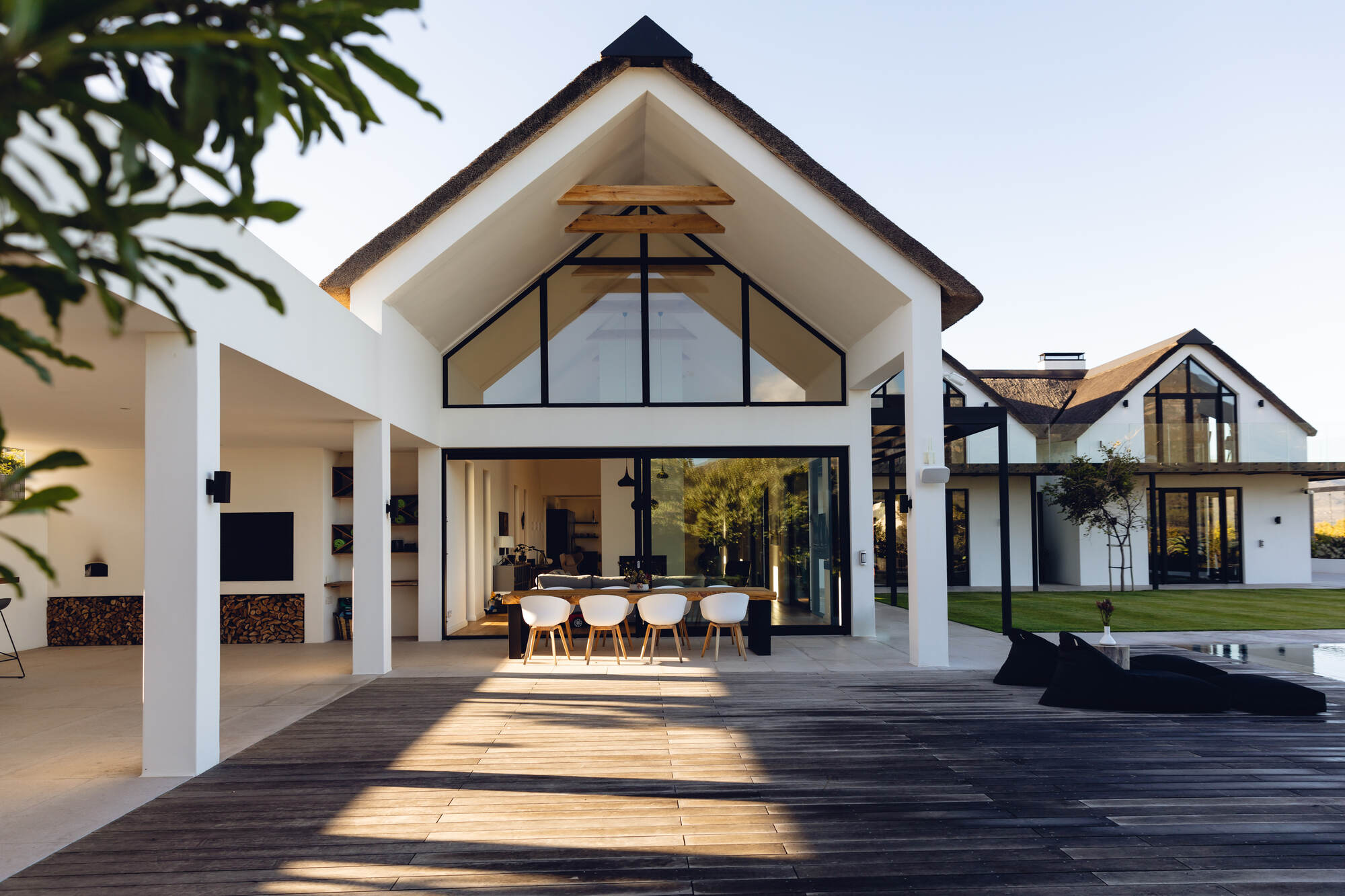 Modern outdoor living space in a custom Roanoke County home by Grace Alon Builders featuring vaulted ceilings and open dining area