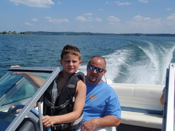 Grace Alon founder Andy with his young son Mason in a boat