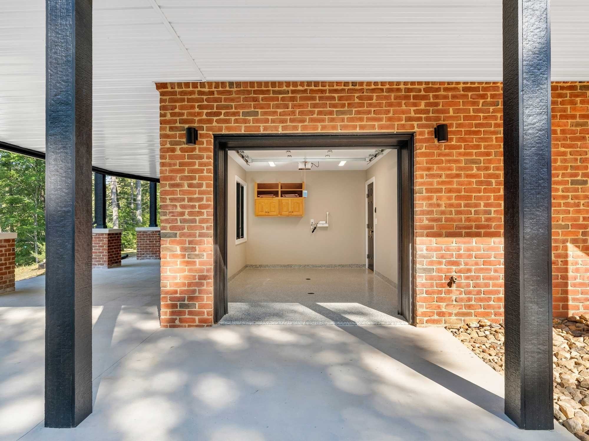 Lower-level brick and concrete features on a home addition by Grace Alon Builders Lower-level brick and concrete features on a home addition by Grace Alon Builders