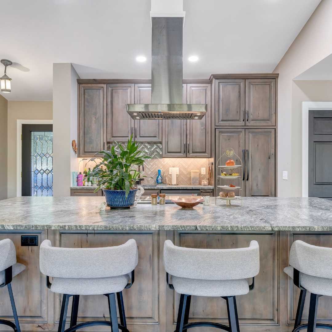 View of the island and the kitchen in the addition by Grace Alon Builders