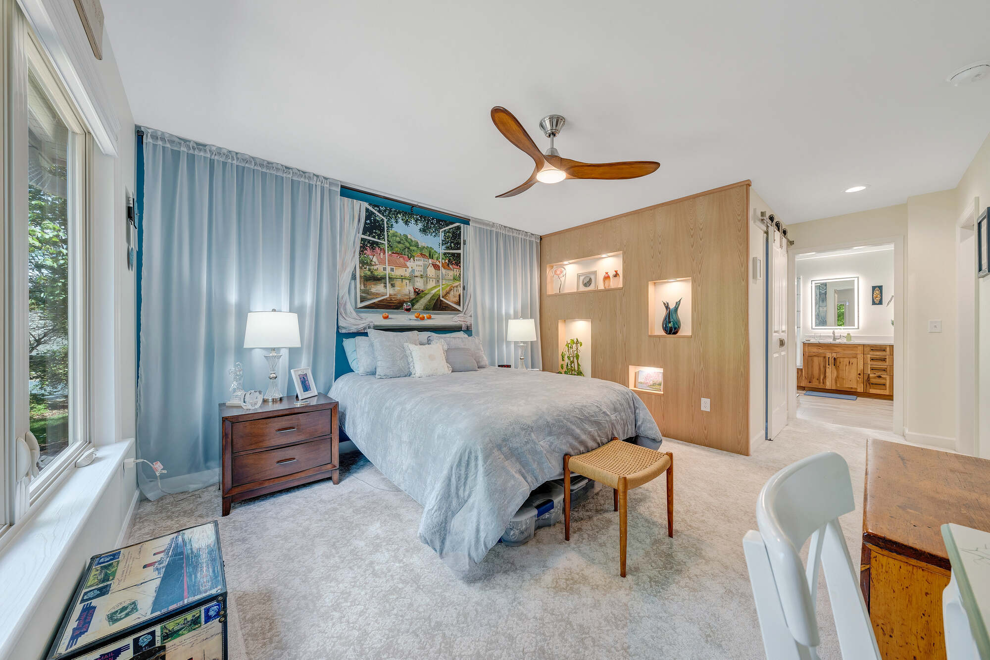 Grace Alon Builders custom bedroom in Smith Mountain Lake featuring built-in shelving and scenic window mural