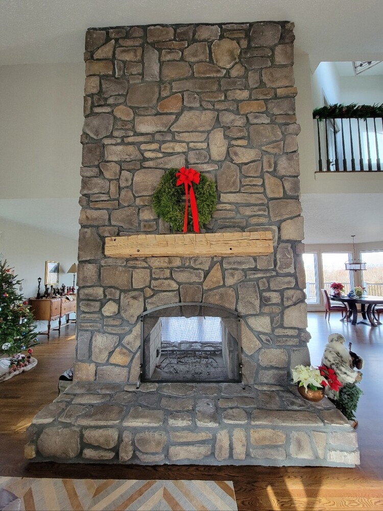 Grace Alon Builders’ custom stone fireplace with Christmas wreath in Roanoke Metropolitan home