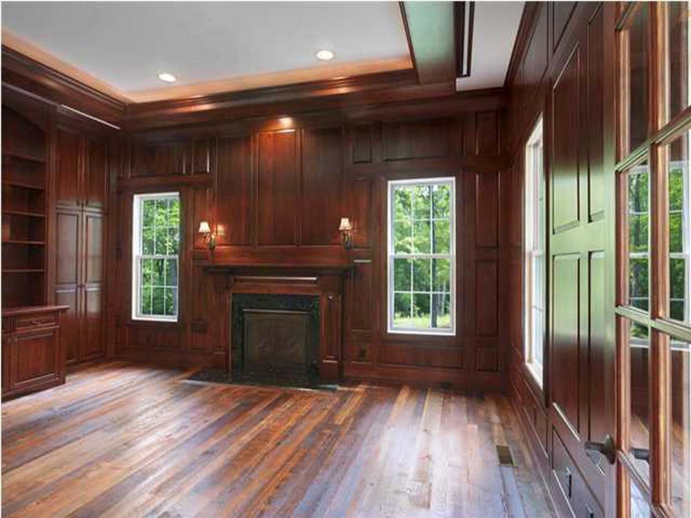 Rich wood-paneled home office interior with fireplace, remodeled by Grace Alon Builders in Roanoke Metropolitan