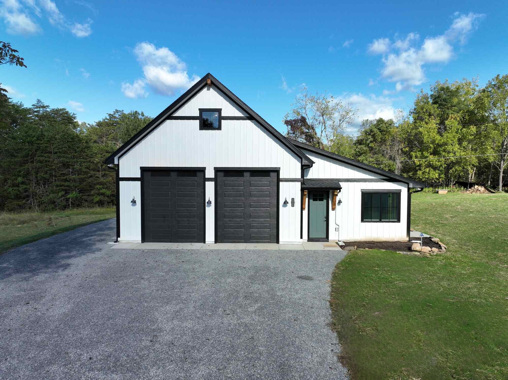 White modern farmhouse garage exterior with black accents built by Grace Alon Builders in the Roanoke Metro