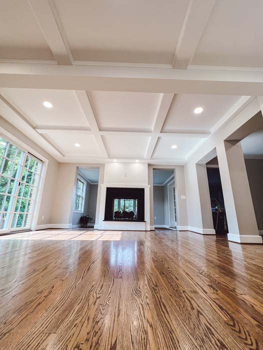 Bright custom living room with coffered ceiling and fireplace built by Grace Alon Builders in Roanoke Metropolitan