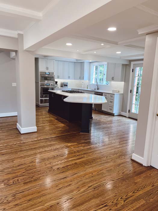 Modern kitchen remodel with white cabinetry and dark island by Grace Alon Builders in Roanoke Metropolitan