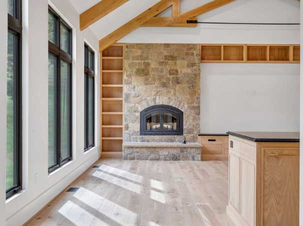 View of the fireplace from the hallway in a custom home by Grace Alon Builders