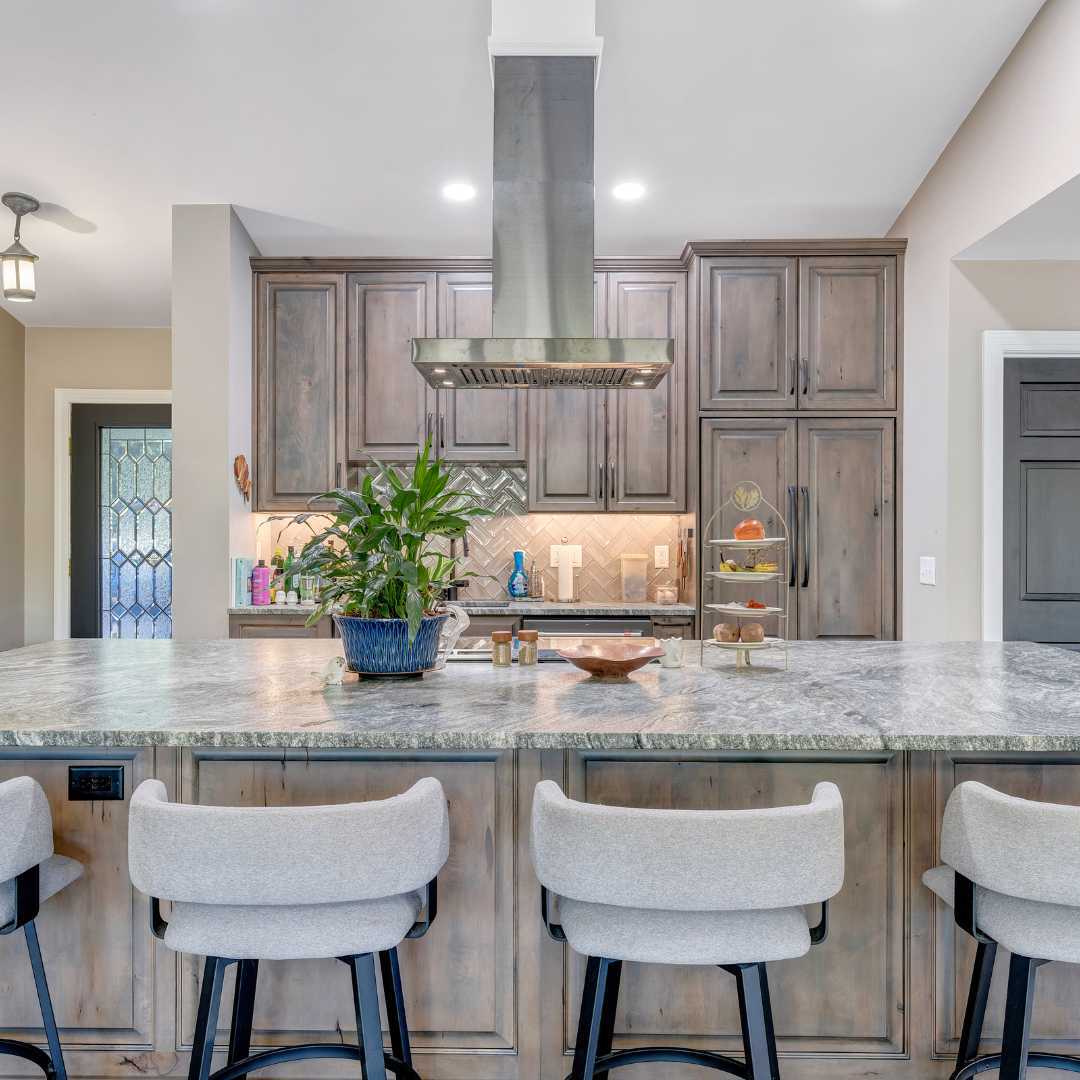 View of the island and the kitchen in the addition by Grace Alon Builders