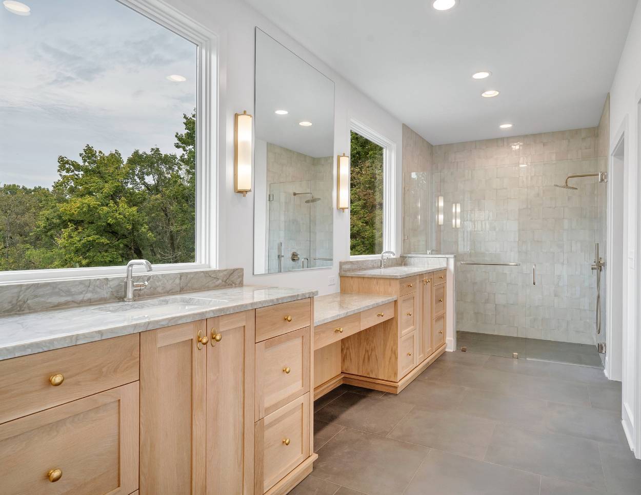 Primary bathroom in a custom home home with a custom vanity and large windows by Grace Alon Builders in Roanoke, VA